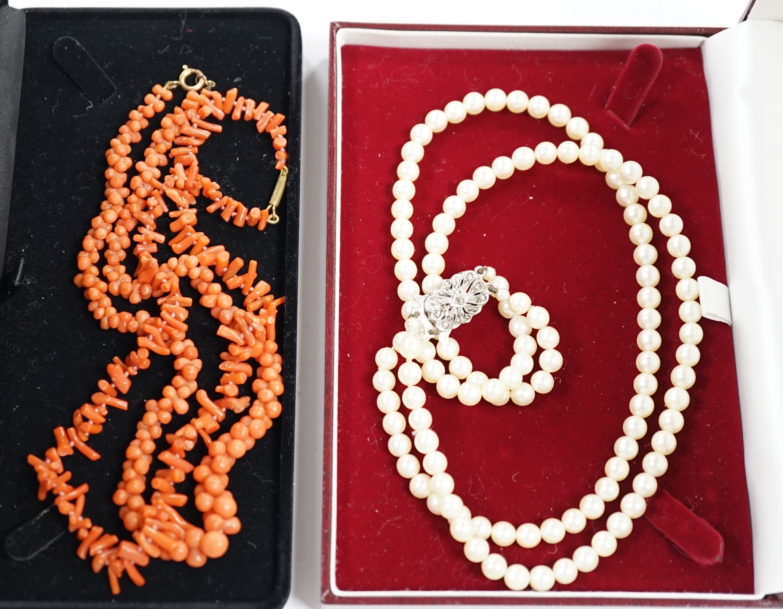 Two coral necklaces, one with beads the other branches, 33cm and a double strand cultured pearl necklace, with marcasite set clasp.